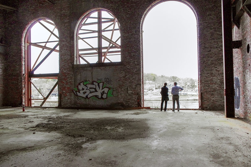 A before photo of South Street Landing, showing a decaying, abandoned building.